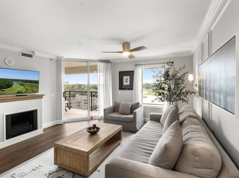 Relax in your bright living room with plush seating, fireplace warmth, and scenic views from your private balcony.