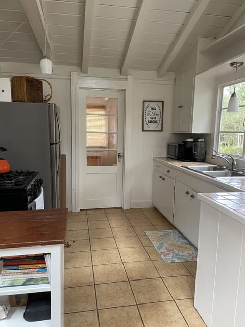 Kitchen has a gas range, microwave, refrigerator, toaster, and Keurig.