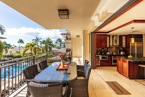 Seamless indoor–outdoor living with a private lanai overlooking the resort pool and tropical grounds.