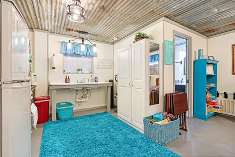 Alternate view of kitchen sink.  Entrance to the bathroom is on the right.