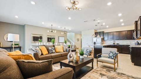 Spacious living room area with cozy sofa, perfect for family reunion.