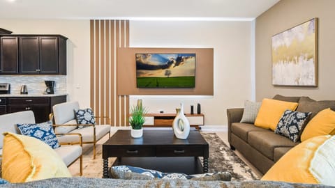 Stylish living area with warm accents, comfy seating, and modern design!