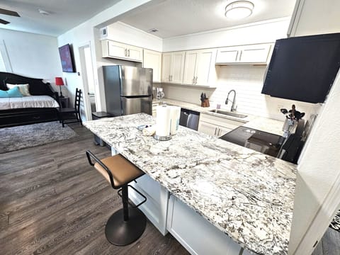 Kitchen with stainless steel appliances and granite countertop.