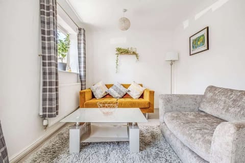 Sink into comfort in the spacious lounge, where a soft sofa and large chair await for chilled movie nights or lazy afternoons