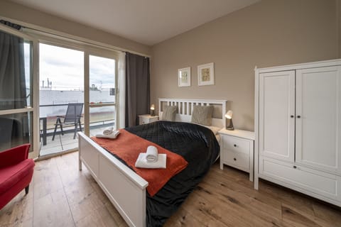 Bedroom 3 with balcony, double bed, wardrobe and work desk 