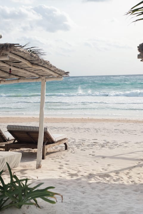 On the beach, white sand, sun loungers