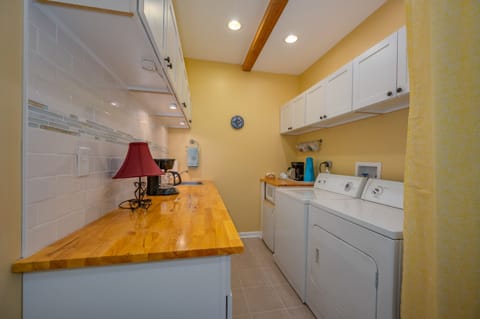 Laundry room area located in lower level of home