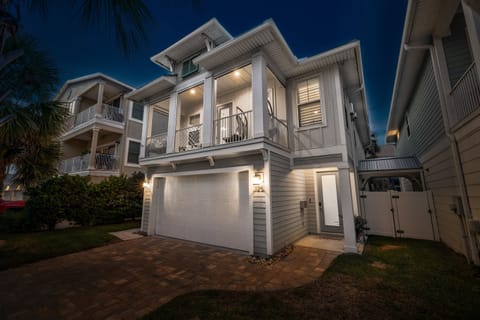 Coastal retreat that shines at night, welcoming you home after a day at the beach.