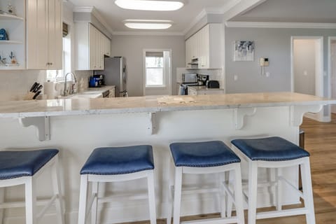 Have a few drinks at the kitchen bar while watching your own chef in action.