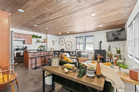 Open fully equipped kitchen, dining area, and living room.