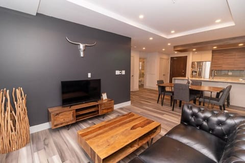 Unwind in the stylish living room with expansive skyline views. Settle into the cozy seating and enjoy your favorite shows on the Smart TV.