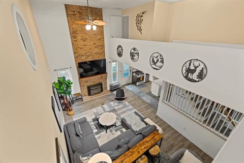 View of living area with decorative fireplace and TV