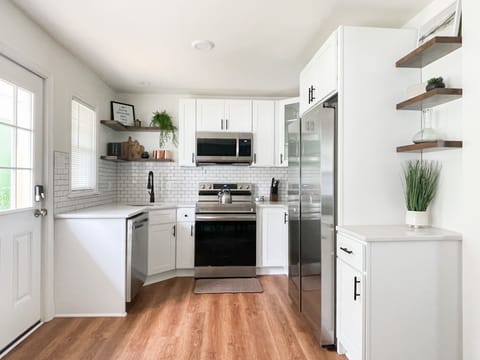 Utensils, dinnerware, pots and pans, and some bakeware are all provided.