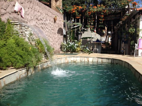 Outdoor pool, open 8 AM to 10 PM, pool umbrellas