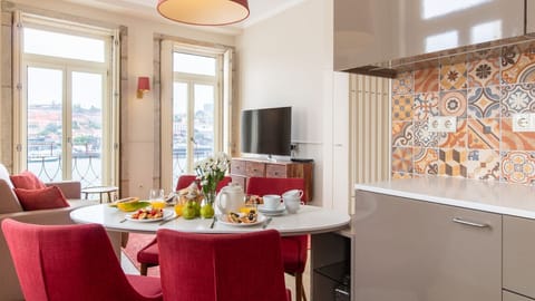 Enjoy a delicious meal at the elegant dining table, perfectly positioned to capture the vibrant river and city views.\n#DiningArea #CityView #LovelyStay