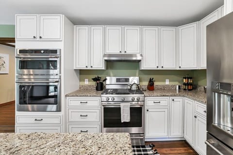 Fully stocked kitchen with Cafe wall microwave and over, gas range and stainless steel fridge