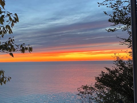 EXTERIOR:  A beautiful sunset on Lake Michigan looking from the cottage.