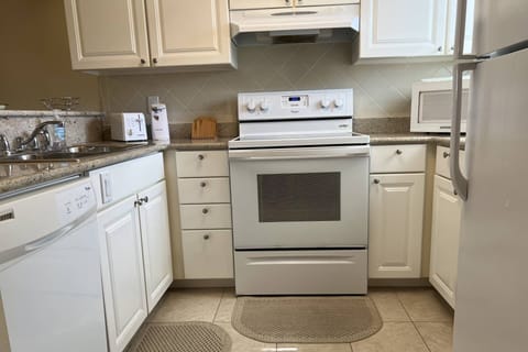 Kitchen area with microwave, coffee maker, toaster, refrigerator, dishwasher, stove and oven!