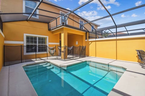 Step outside to find your private oasis, featuring a sparkling pool set against vibrant yellow walls. Relax on sleek lounge chairs and savor the fresh air in this inviting, well-enclosed space. Enjoy your perfect escape!