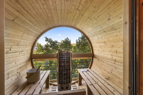 Barrel sauna has a panorama viewing window to take in the great outdoors!