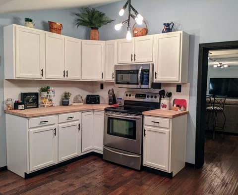 Full-size appliances and all necessities to cook a full meal in the cabinets.