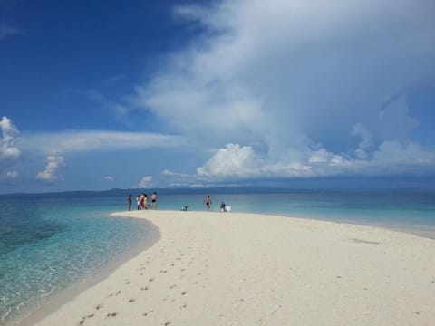 On the beach, white sand, sun loungers, beach umbrellas