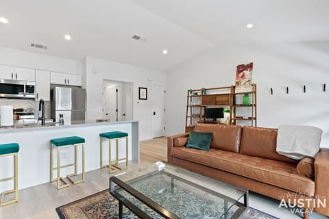 Beautiful and open living space with large island, sofa and office