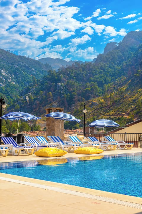 Seasonal outdoor pool, open 9:00 AM to 7:30 PM, pool umbrellas