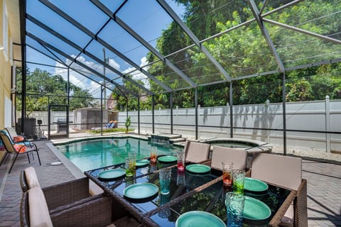 Outdoor dining area that seats 8, with luxury heated pool, spa and BBQ grill