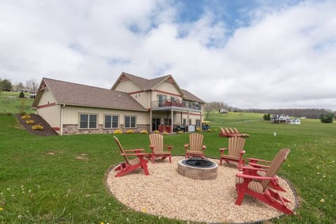back view of home with outdoor firepit