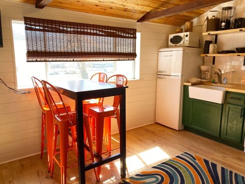 The dining table is a countertop height table that seats 4.