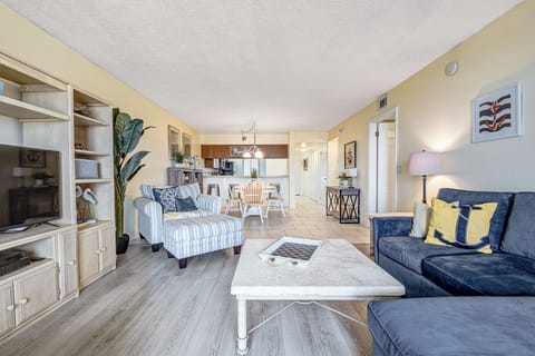 Living room adjacent to kitchen and dining are