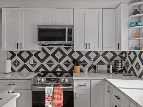 Kitchen picture of Microwave and oven, with our plentiful cabinets that contain plenty of utensils!