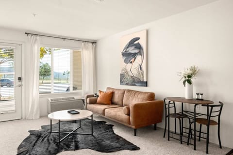 XL couch next to dining table that seats 2