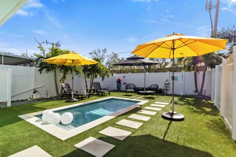Private heated pool with plenty of seating and lounge chairs