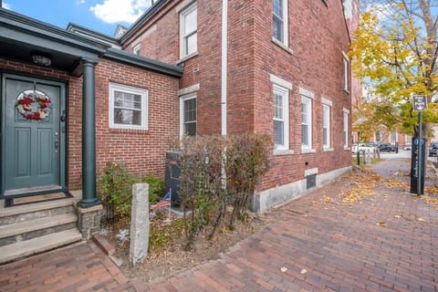 Enter a world of tranquility with keyless access to our enchanting retreat, where exposed brick and picturesque landscaping welcome you with open arms