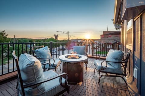 Enjoy an exclusive experience with the Ruby Suite, featuring a private balcony showcasing breathtaking city views and a cozy fire table for your relaxation and pleasure.