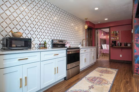 Cook, reheat, or just sip coffee in this full kitchen with floor-to-ceiling tile, a stocked coffee/tea bar, and all the essentials—plus fun extras like chocolate syrup and cinnamon toppings. Guests say it’s “cute, clean, and had everything we needed.”