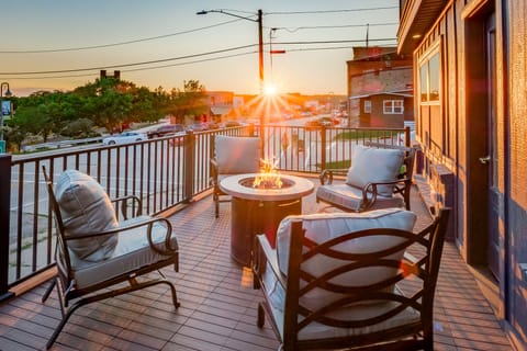 Your own private downtown overlook. This spacious 300 sq ft deck features cozy seating, a propane fire table, and the perfect perch for morning coffee, evening wine, or just people-watching along Broad Street.
