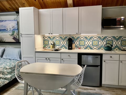 Kitchenette has a microwave/ oven, mini fridge, 2 burner hotplate, sink