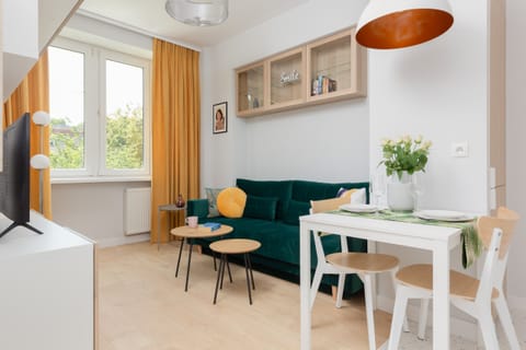 A combination of a modern living area with a comfortable sofa combined with a dining area with a comfortable dining table.
