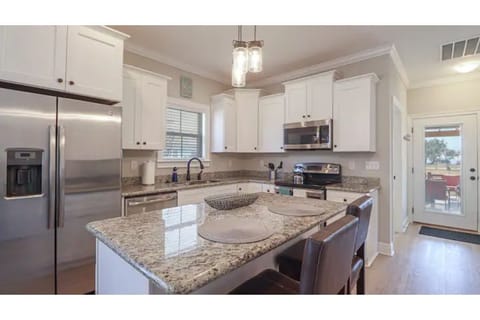 Modern kitchen design and stocked with appliances, dishes, pans, coffee pot, etc