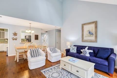 Living room with flatscreen tv and a queen sleeper sofa.