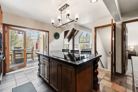 Step into your open-concept kitchen where rustic charm meets modern comfort. Natural light floods through large windows as you prepare meals.