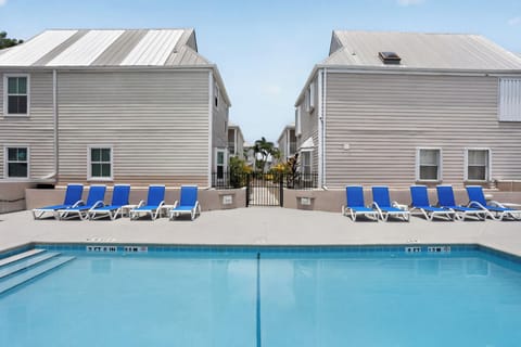 Community pool with lounge chairs and shaded seating for easy days in the sun.