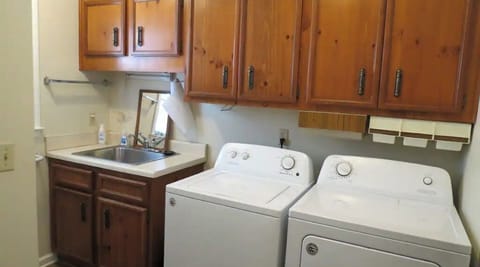 Full laundry with washing/cleaning supplies. 1/2 bath included in laundry room.