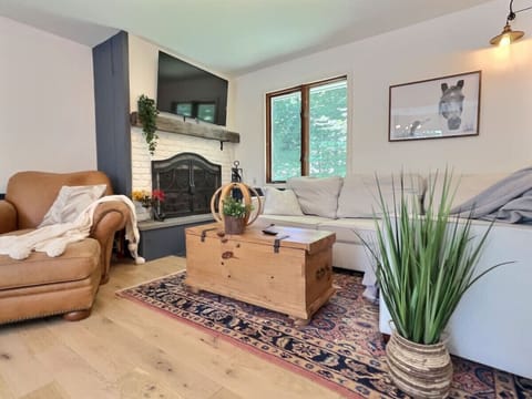 Cozy up in our living room with family and friends around the charming fireplace
