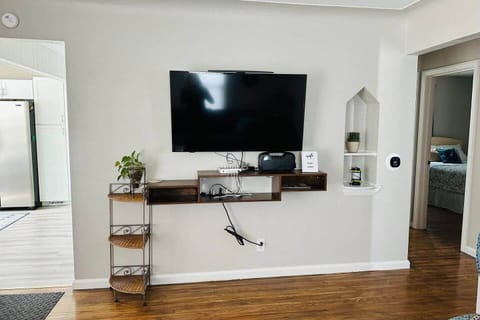 Living room main floor TV 50", Blue tooth boom speaker, and phone charging station. 