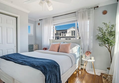 Your serene sanctuary by the shore. This bright bedroom features a plush mattres