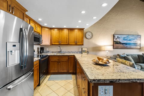 Beautifully remodeled kitchen featuring granite countertops and full-size stainless steel appliances.